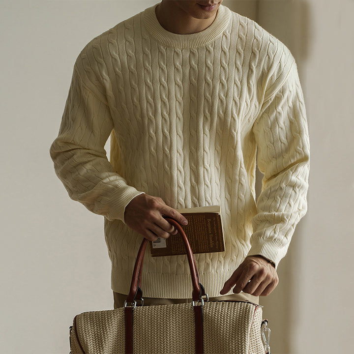 Men's cream cable-knit crew neck sweater styled for fall and winter. Chunky knit pullover ideal for cozy and casual outfits.