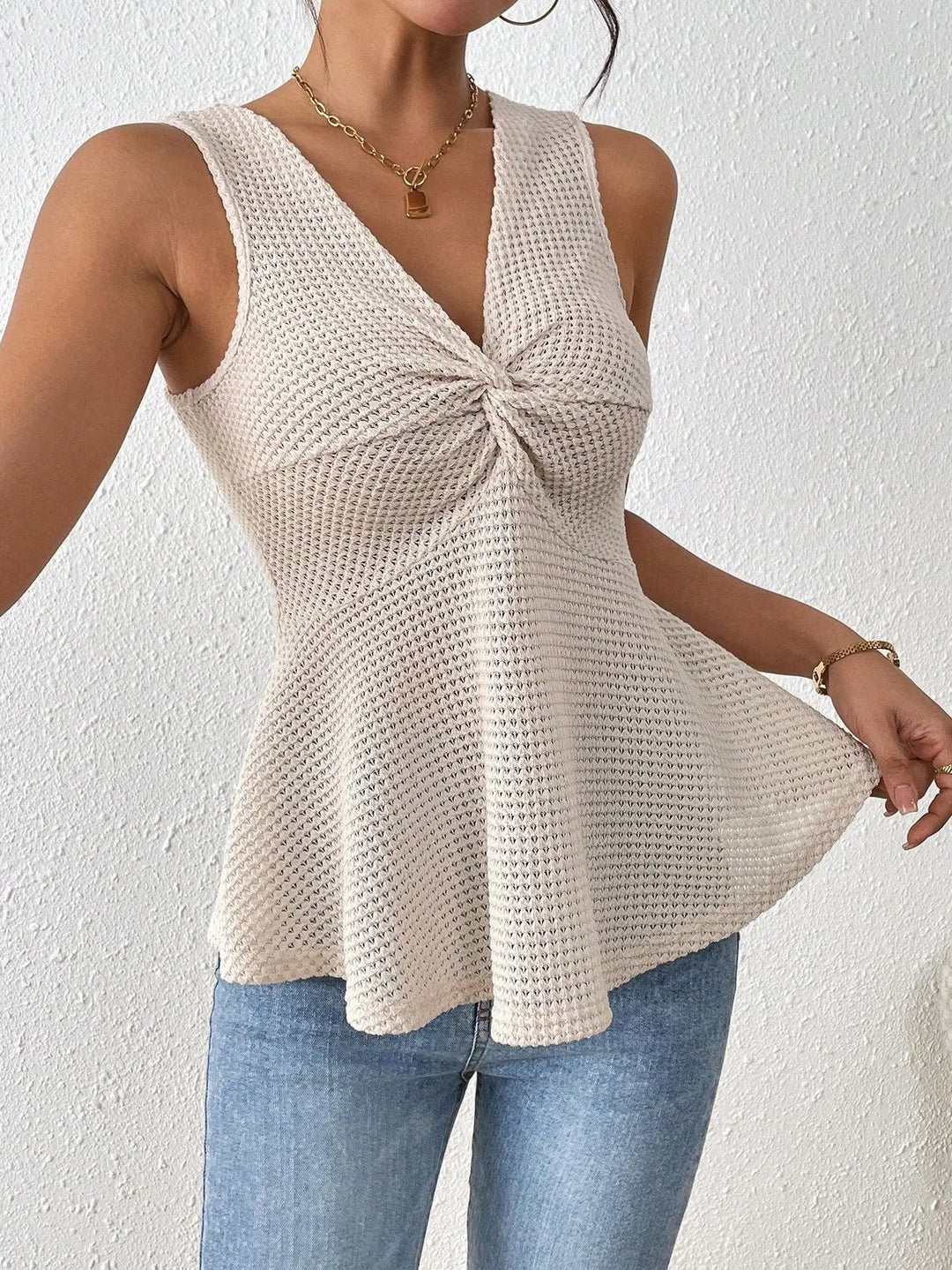 Women’s beige sleeveless knit peplum top with twisted front detail – casual summer fashion
