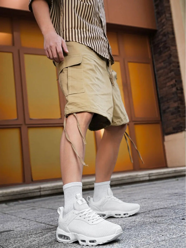 Person wearing beige cargo shorts and white sneakers