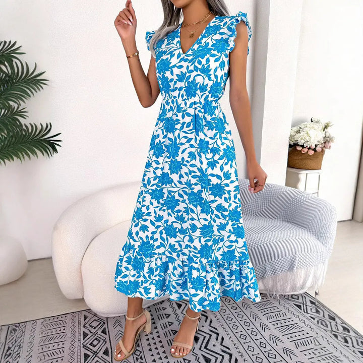 Women’s blue floral midi dress with white flower print, flutter sleeves, V-neckline, and ruffle hem – elegant summer outfit