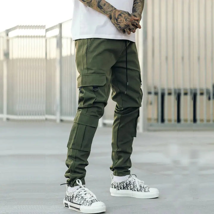 Olive green urban cargo pants for men with multiple zipper pockets – street style