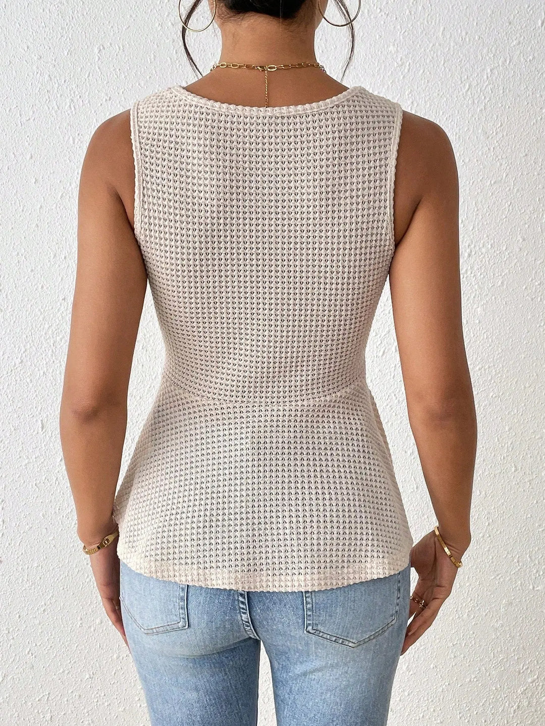 Women’s beige sleeveless knit peplum top with twisted front detail – casual summer fashion