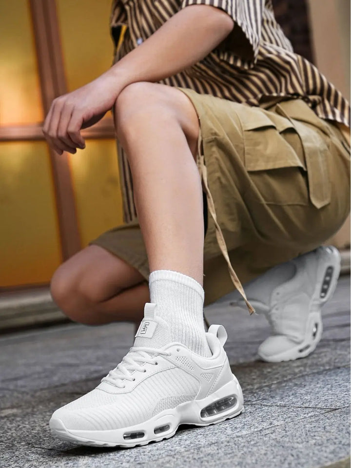 Person wearing white sneakers with a blurred background