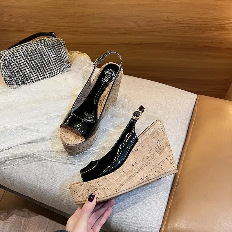 A pair of open-toe platform heels with a textured upper in black color