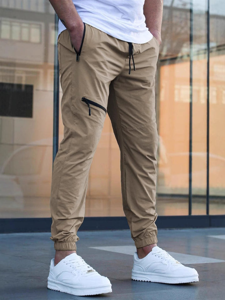 Beige tapered cargo joggers for men – modern utility-style pants for relaxed street fashion.