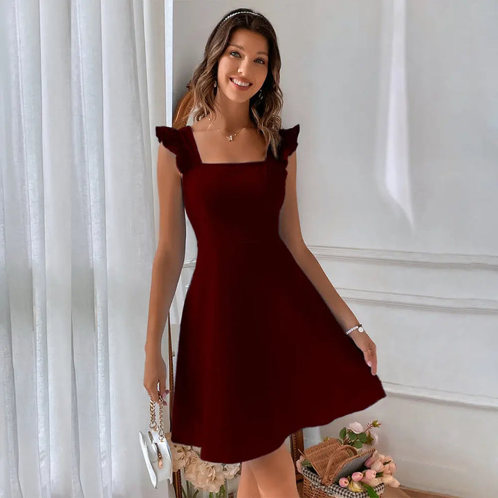 A woman wearing a red sleeveless knee-length dress with ruffled shoulder straps.