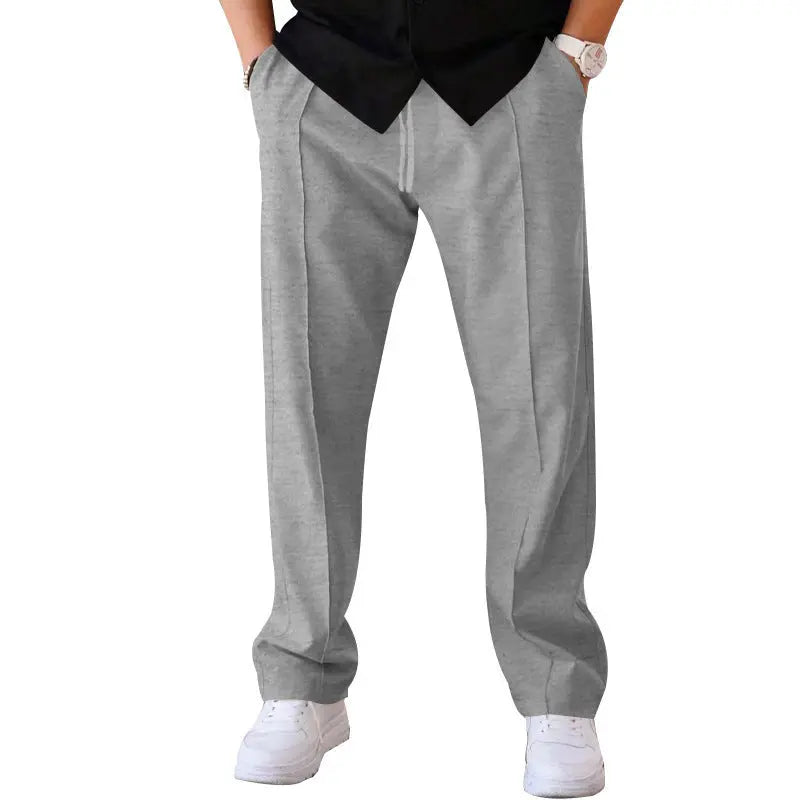 Men’s light grey wide-leg pants with tailored waist and flowing structure – fashion-forward alternative to chinos
