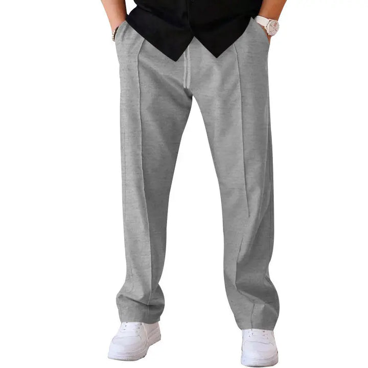 Men’s light grey wide-leg pants with tailored waist and flowing structure – fashion-forward alternative to chinos