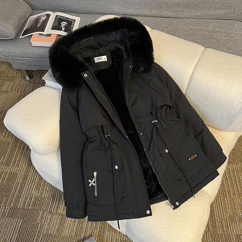 Warm fur-lined winter jacket for women in black – stylish utility parka with multiple pockets for cold-weather outfits.