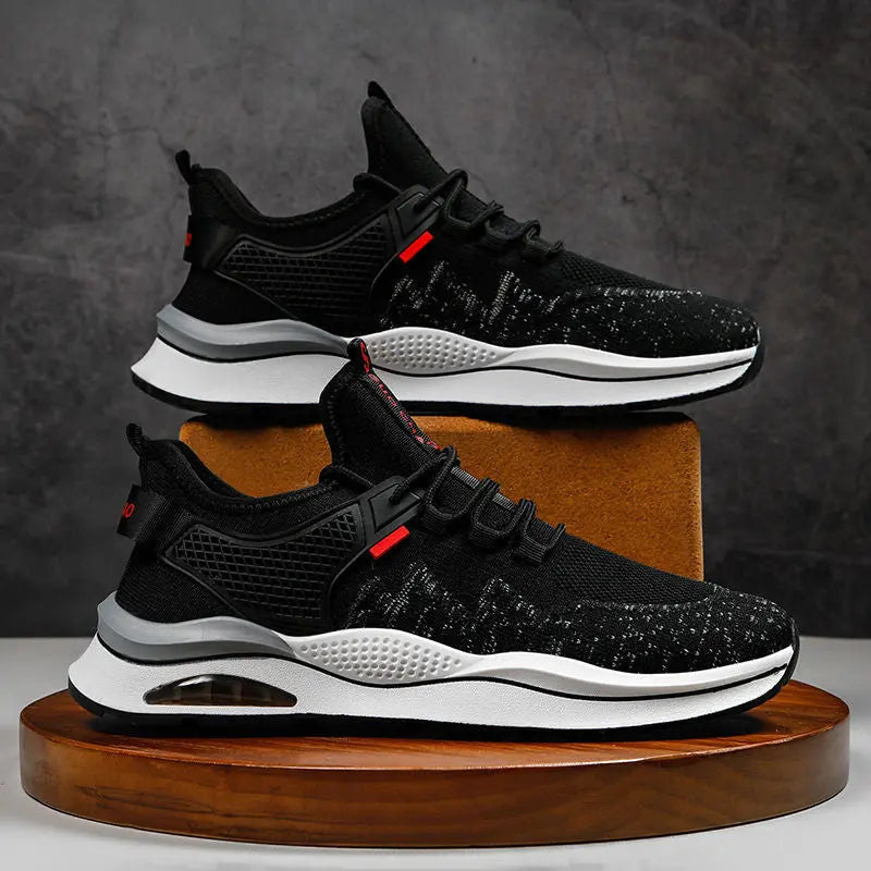 A pair of black and white sneakers with red accents
