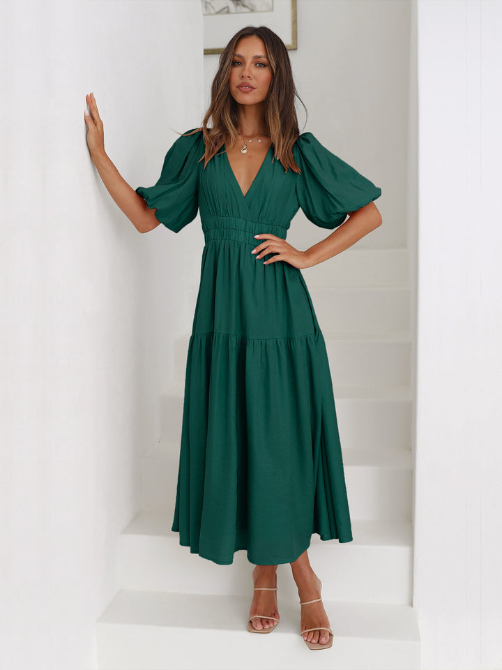 Green V-neck midi dress with short sleeves – flowy and flattering silhouette for chic summer fashion.