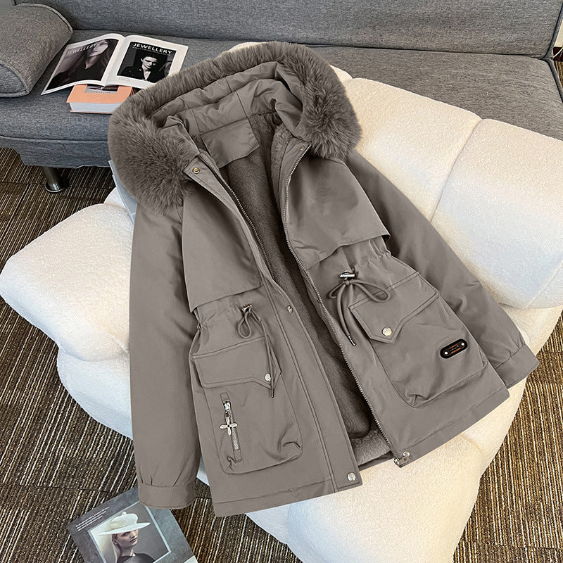 Warm fur-lined winter jacket for women in grey – stylish utility parka with multiple pockets for cold-weather outfits.