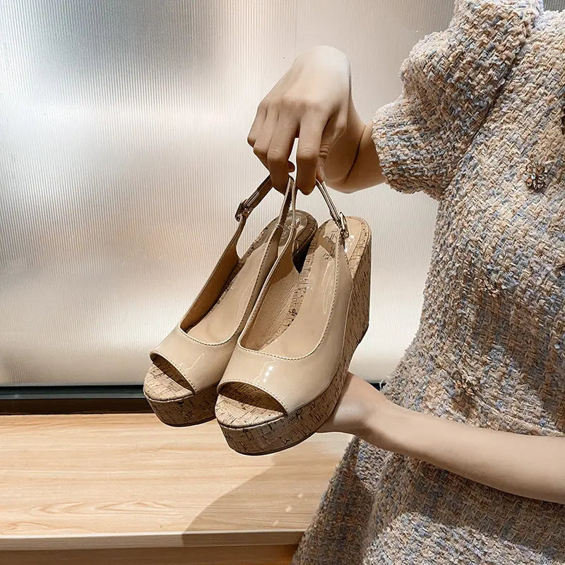 A pair of open-toe platform heels with a textured upper in beige