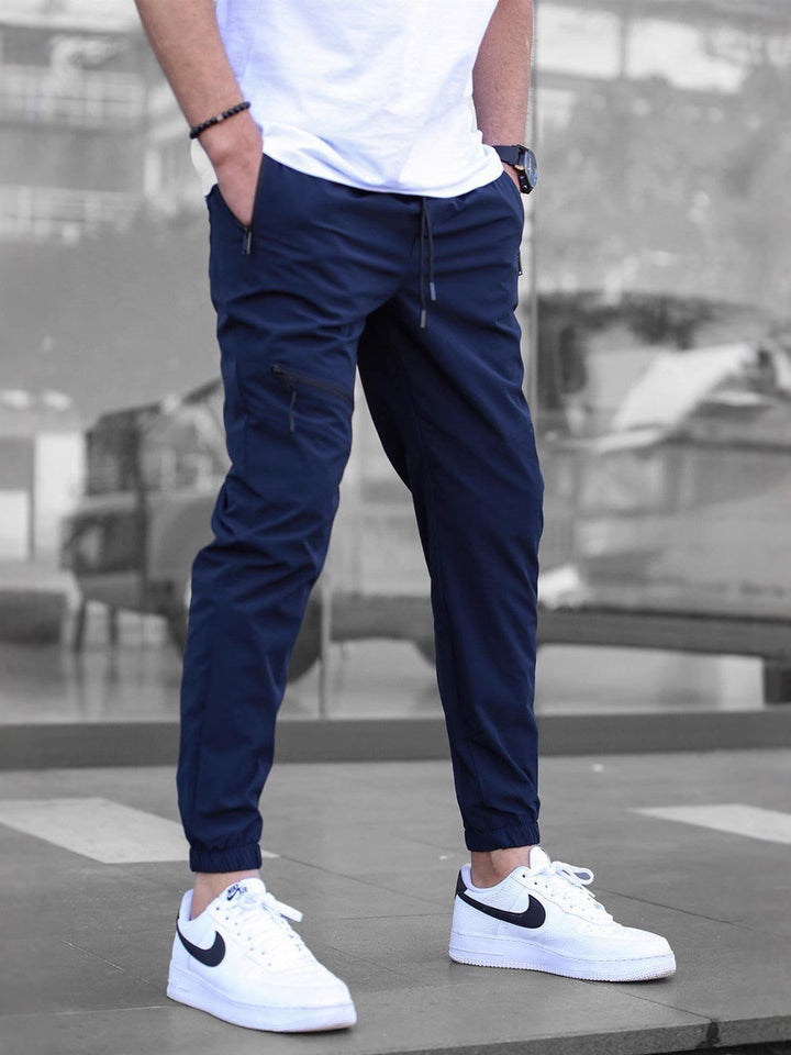 Navy blue men’s tapered cargo joggers – stylish and functional pants with urban utility vibe.