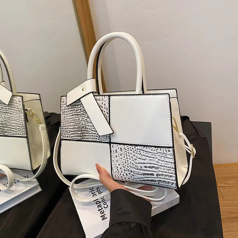 Trendy white patchwork handbag for women featuring croc-embossed leather texture and detachable shoulder strap.