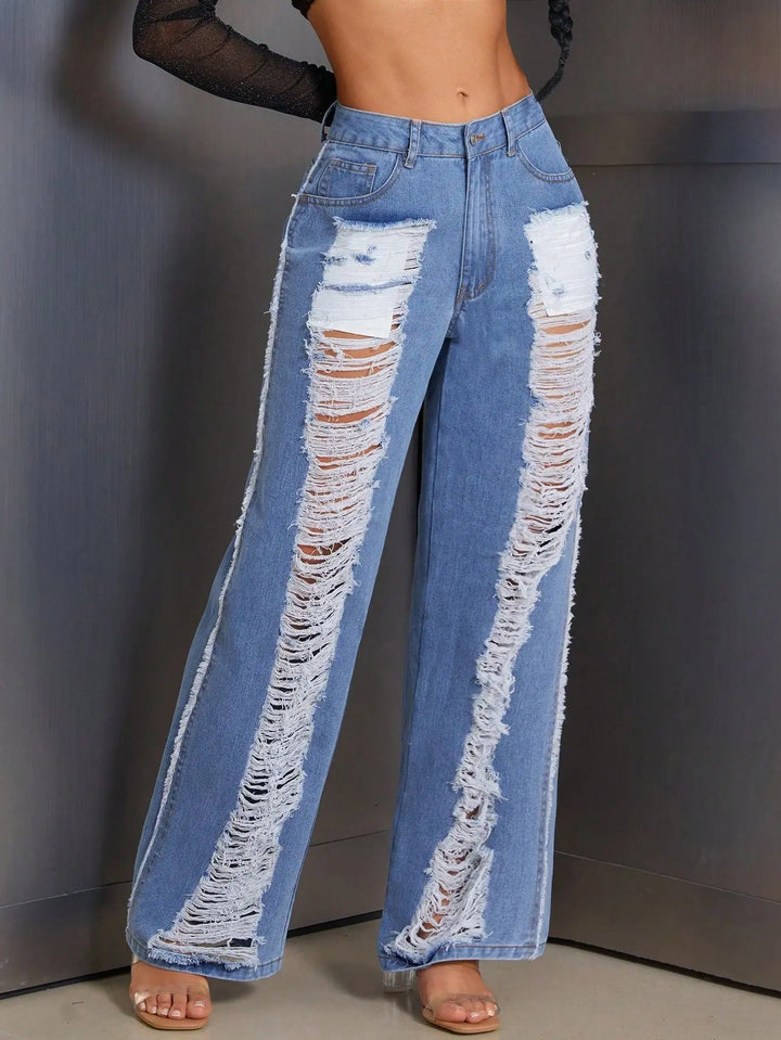 Women’s high-waisted blue wide-leg jeans with extreme distressed rips – edgy Y2K street style denim