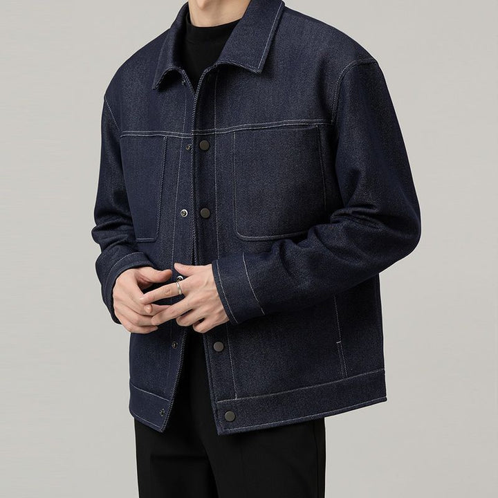Men’s dark blue classic denim jacket with clean stitched detailing – minimalist casual outerwear for modern everyday looks.