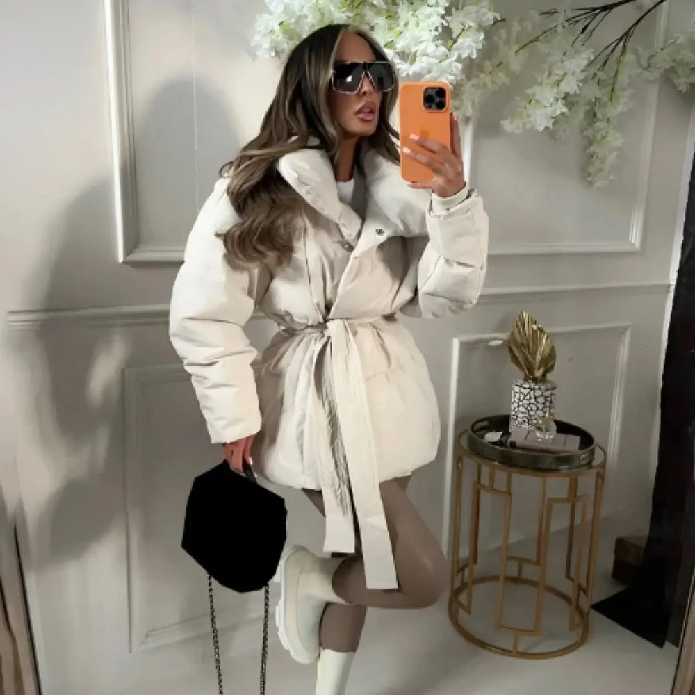 Elegant white belted puffer jacket for women with wide collar – chic winter fashion piece.