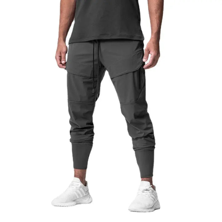Men’s dark grey tactical sweatpants with multiple zippered pockets – functional joggers for training or casual wear