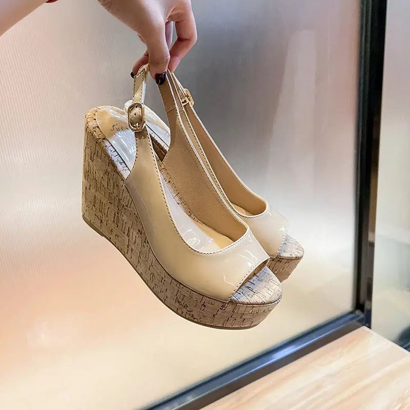 A pair of open-toe platform heels with a textured upper in beige