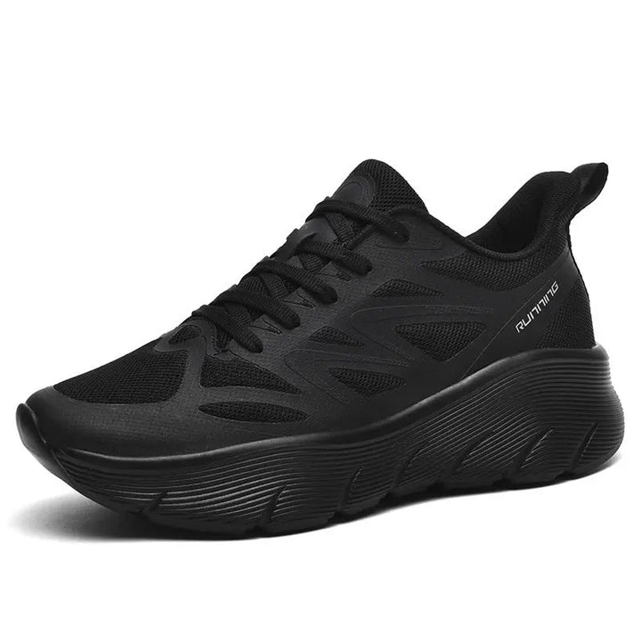 A pair of black ActiveGlide Sports Shoes placed on a pedestal, showcasing the sole design