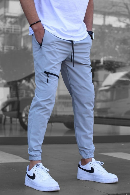 Light grey men’s tapered cargo joggers – comfortable drawstring waist pants with zippered pockets for casual and sporty looks.