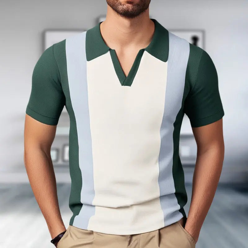 A man wearing a green and white color-blocked V-neck slim polo shirt with a tailored fit.