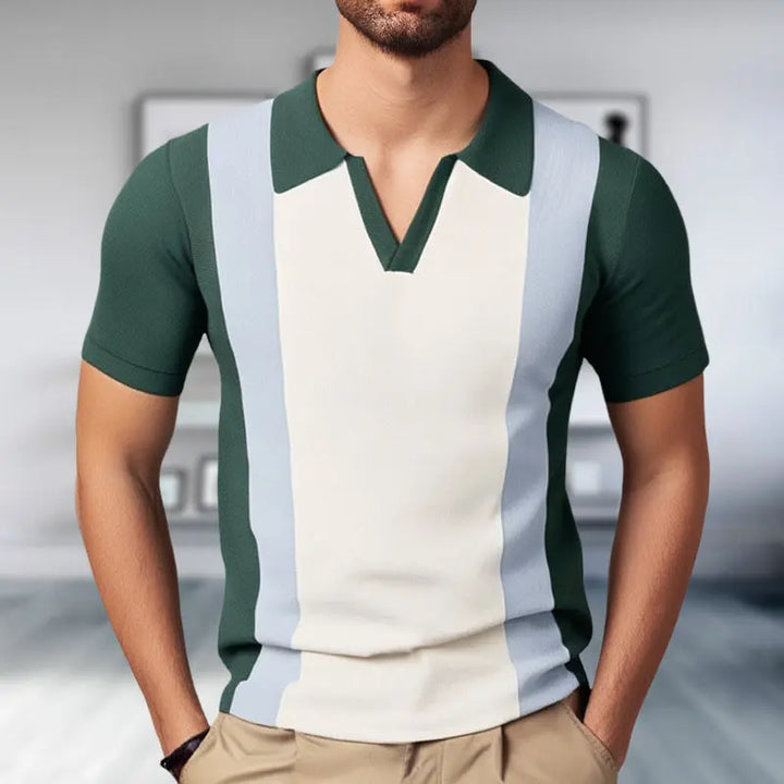 A man wearing a green and white color-blocked V-neck slim polo shirt with a tailored fit.