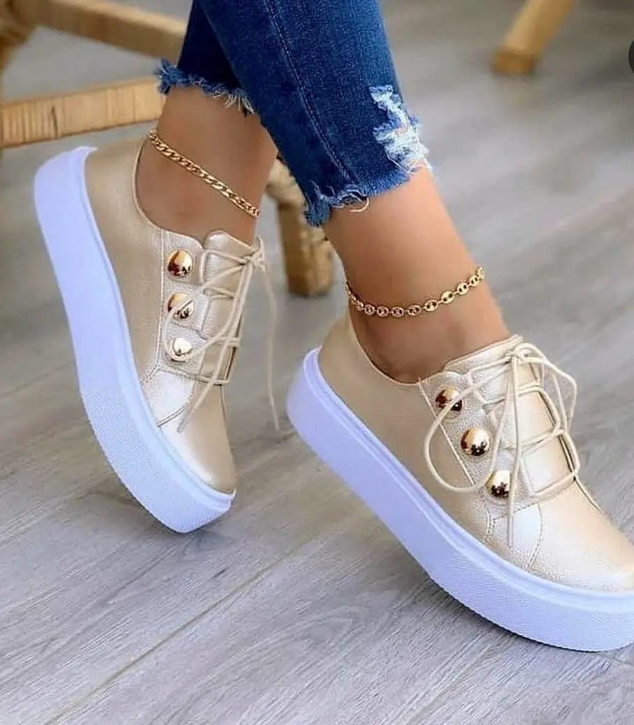 Beige sneakers with gold accents