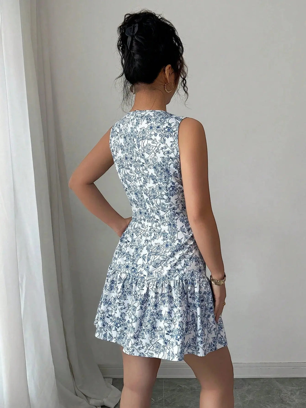 Women’s blue and white floral sleeveless mini dress with tiered skirt – elegant summer brunch outfit