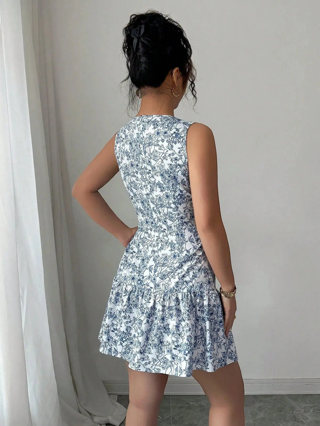 Women’s blue and white floral sleeveless mini dress with tiered skirt – elegant summer brunch outfit