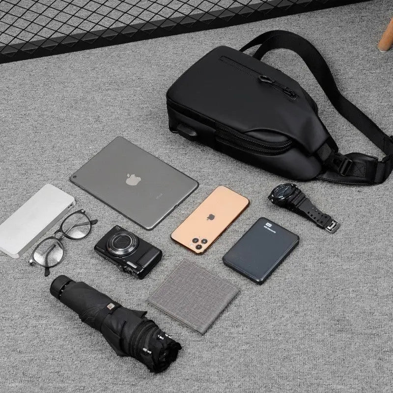 Men’s black waterproof anti-theft sling chest bag with USB charging port – compact crossbody for travel and daily use