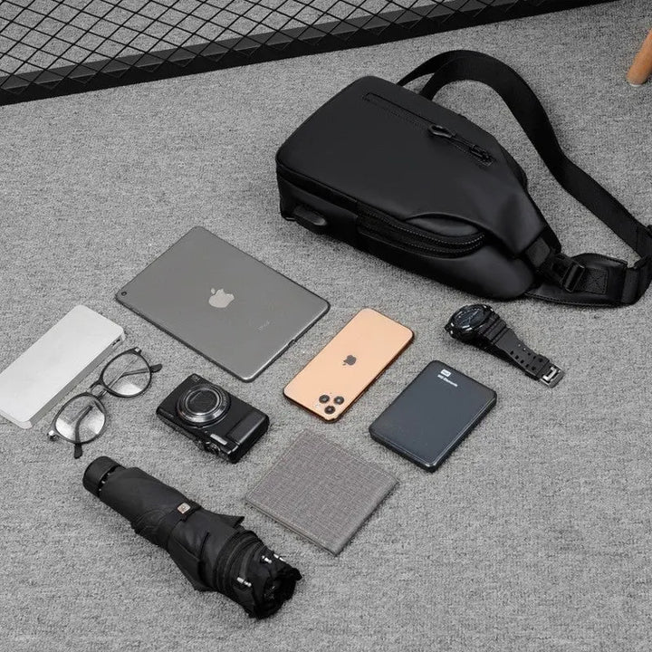 Men’s black waterproof anti-theft sling chest bag with USB charging port – compact crossbody for travel and daily use