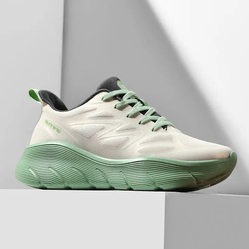 A pair of white and green ActiveGlide Sports Shoes placed on a pedestal, showcasing the sole design