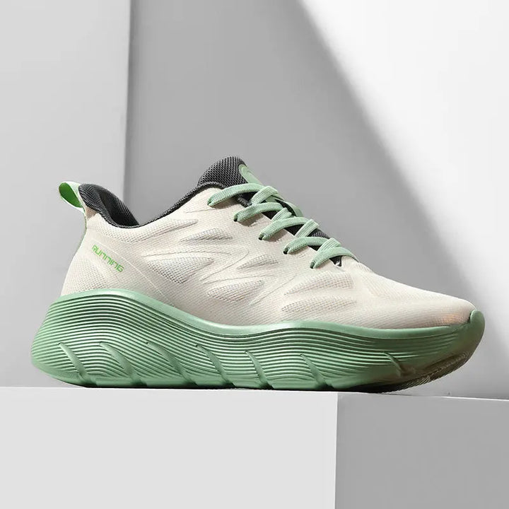 A pair of white and green ActiveGlide Sports Shoes placed on a pedestal, showcasing the sole design