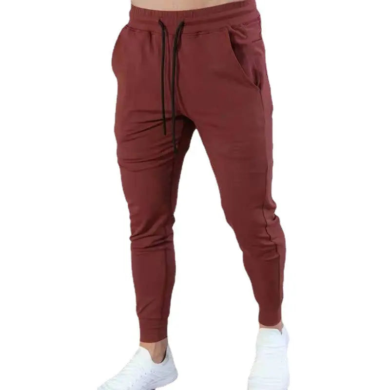 Burgundy red men’s slim-fit joggers with multiple pockets – sporty and stylish sweatpants for gym or streetwear