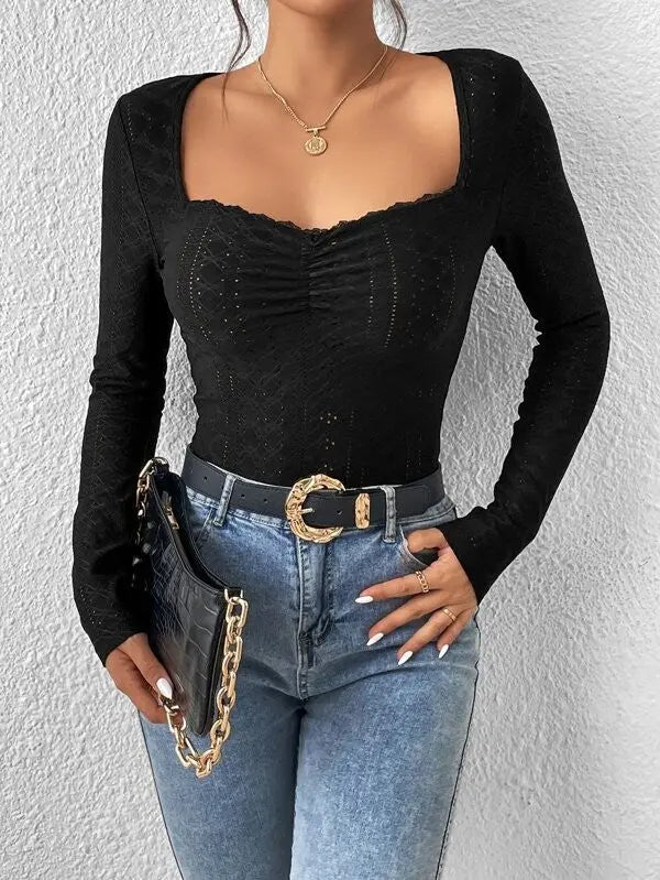 Women's black long-sleeve top with eyelet details