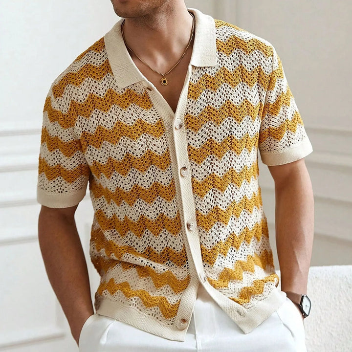 Man wearing a yellow and white patterned cardigan