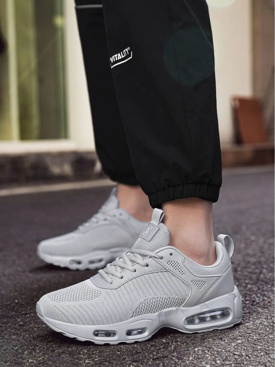 Gray sneakers worn with black pants
