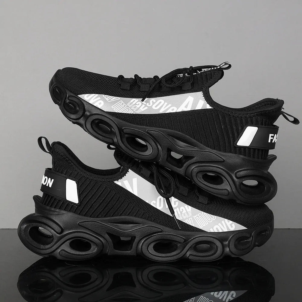 A pair of black and white sports sneakers with a breathable mesh upper and a unique sole design, displayed against a grey background.