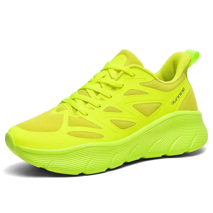 A pair of yellow ActiveGlide Sports Shoes placed on a pedestal, showcasing the sole design