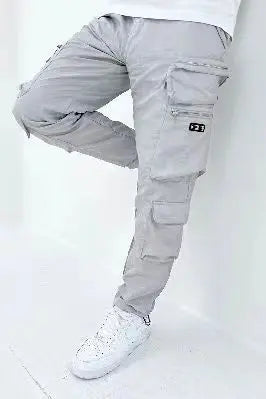 A pair of men's casual gray trousers with multiple pockets and zippers, designed for versatility and functionality.