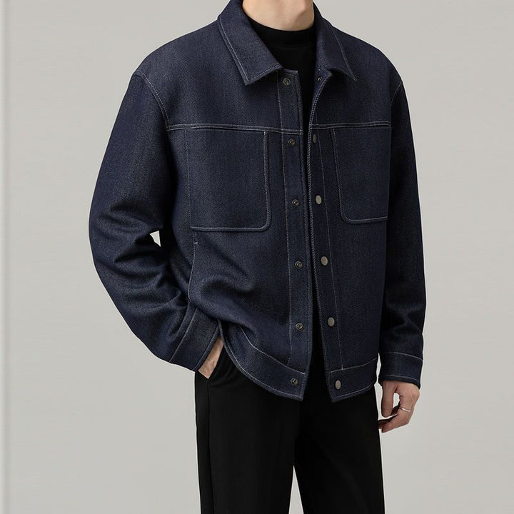 Men’s dark blue classic denim jacket with clean stitched detailing – minimalist casual outerwear for modern everyday looks.