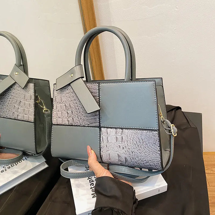Trendy light blue patchwork handbag for women featuring croc-embossed leather texture and detachable shoulder strap.