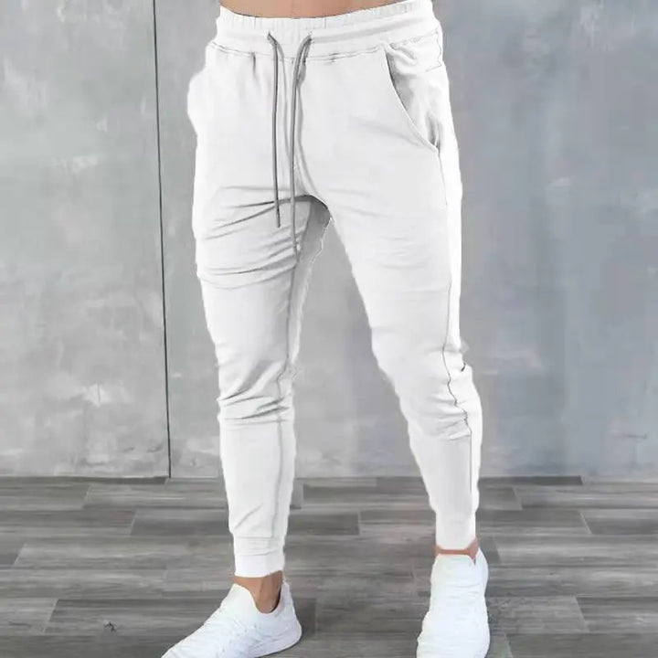 White men’s jogger sweatpants with cuffed ankles and zippered pockets – minimalist style for active lifestyle