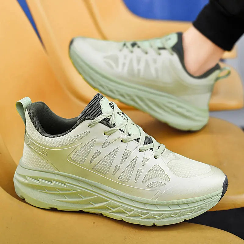 A pair of light green PureFit Sports Shoes placed against a yellow background, showcasing the side profile of the sneakers with laces and the sole.