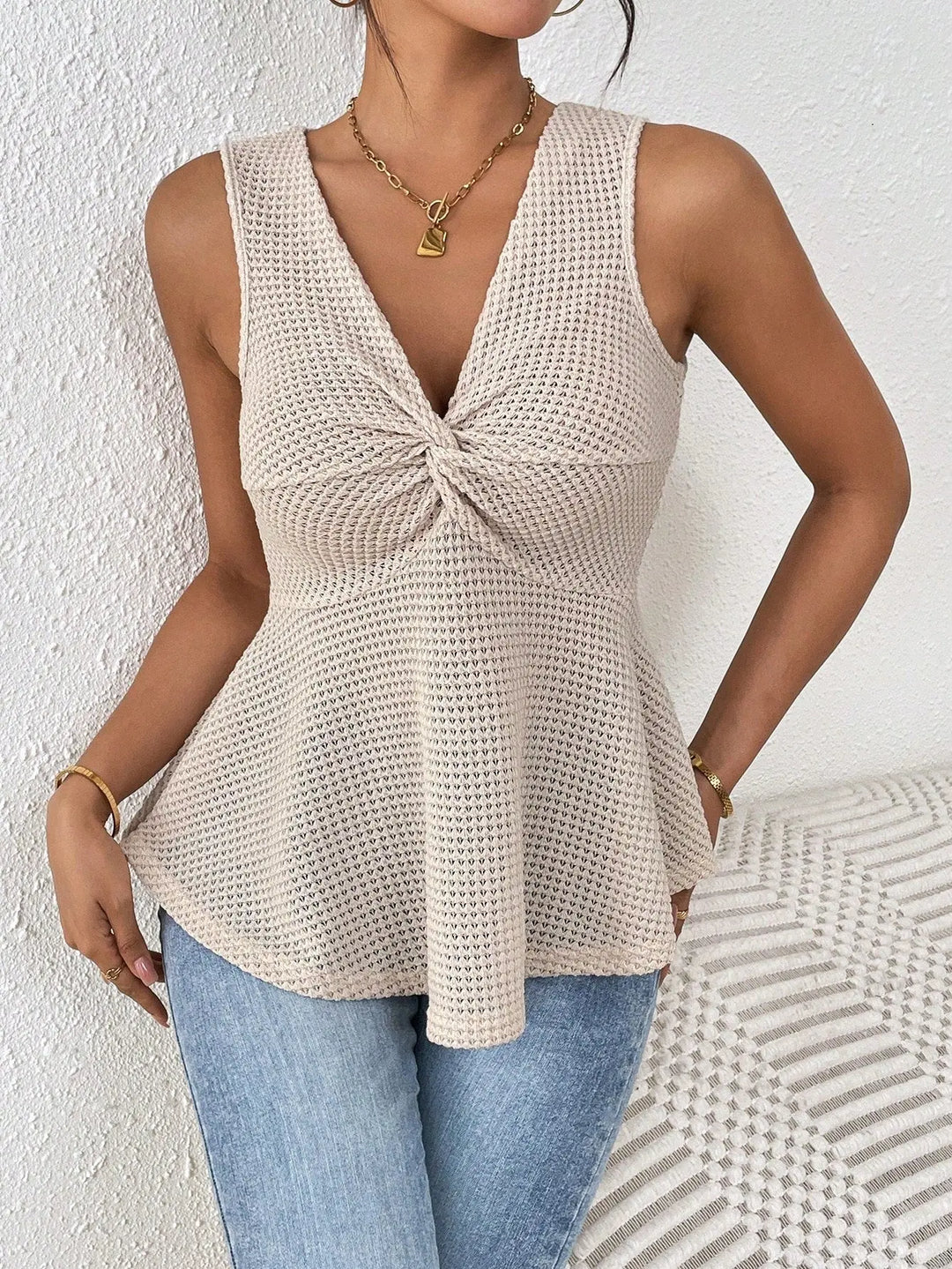 Women’s beige sleeveless knit peplum top with twisted front detail – casual summer fashion