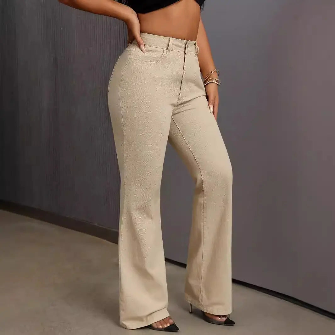 A woman wearing a black crop top and beige wide-leg high-waisted jeans