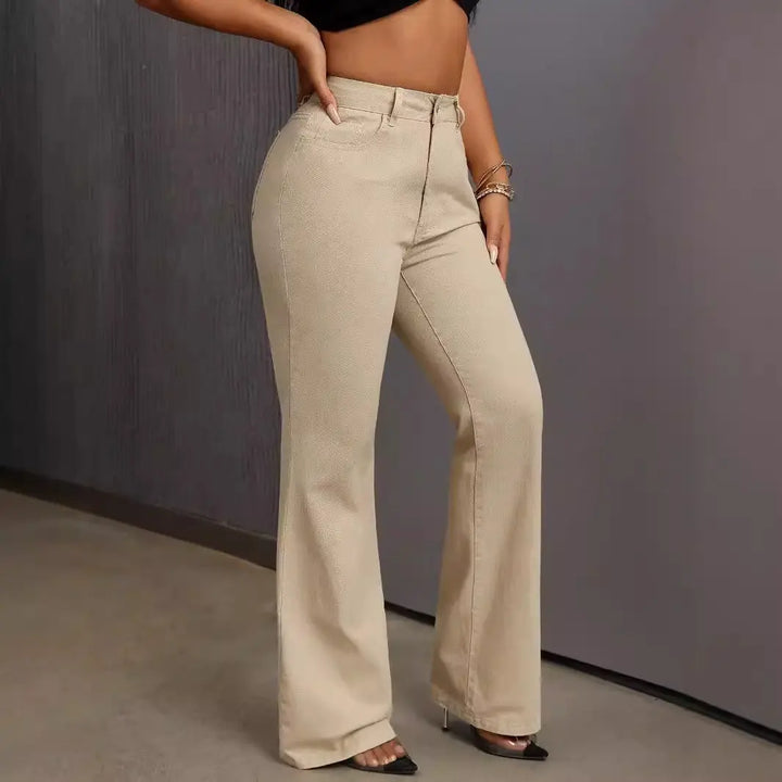 A woman wearing a black crop top and beige wide-leg high-waisted jeans