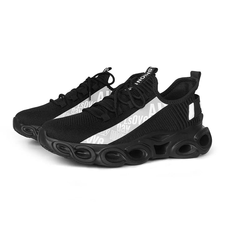 A pair of black and white sports sneakers with a breathable mesh upper and a unique sole design, displayed against a grey background.
